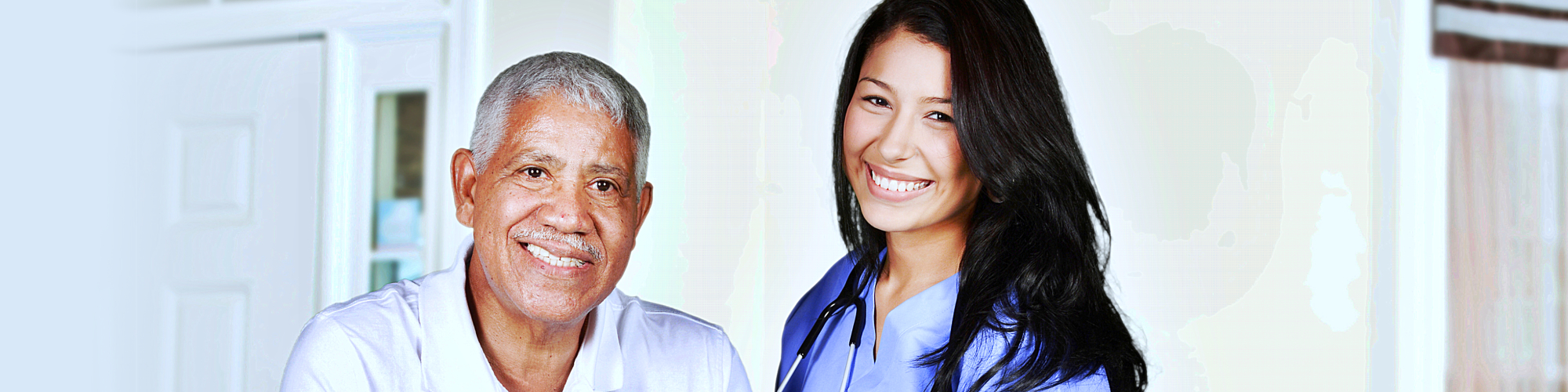 senior man and female caregiver smiling